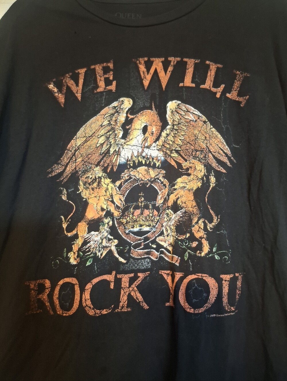 Queen Black 'We Will Rock You' Graphic Tee with Orange-Gold Crest